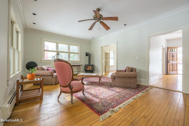 5 Stockbridge Rd, West Stockbridge, MA 01266 - living area featuring a wood stove, light wood-style flooring, baseboard heating, ceiling fan, and baseboards