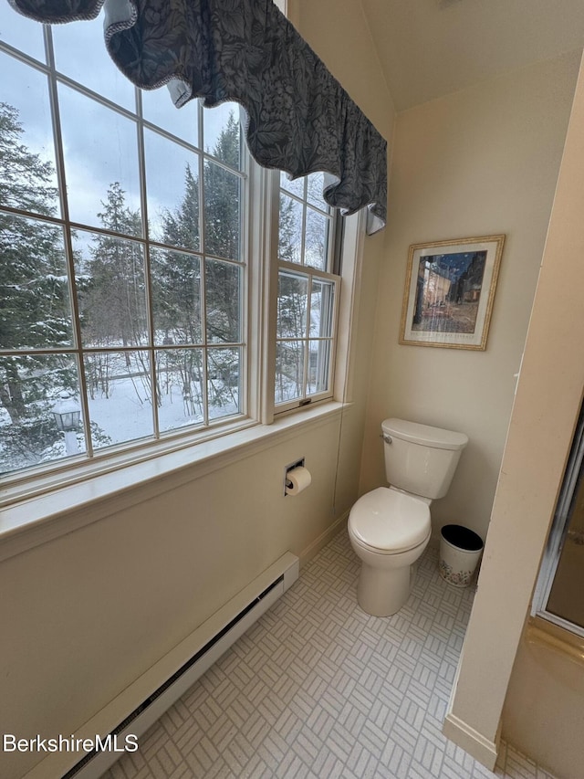 bathroom featuring toilet, tile patterned floors, and baseboard heating