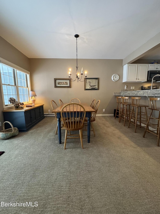 dining space with carpet flooring and a chandelier