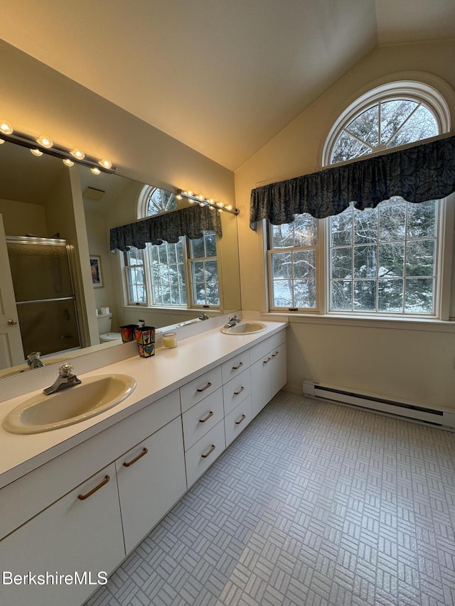 9122 Mountainside Dr, Hancock, MA 01237 - full bath with a baseboard radiator, vaulted ceiling, toilet, double vanity, and a stall shower