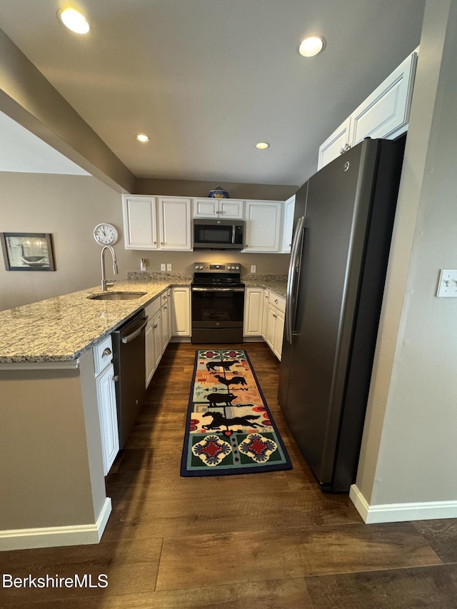 9122 Mountainside Dr, Hancock, MA 01237 - kitchen featuring stainless steel appliances, a sink, light stone counters, dark wood-style flooring, and recessed lighting