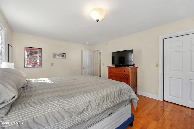 bedroom with light wood-type flooring and baseboards