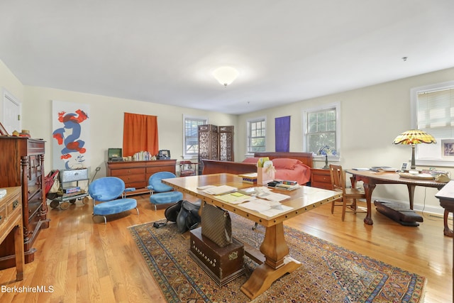 dining room featuring baseboards and light wood-type flooring