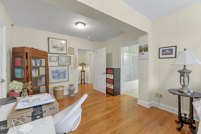 office area with light wood-type flooring and baseboards