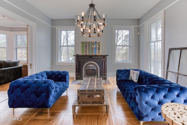 21 Stockbridge Rd, West Stockbridge, MA 01266 - living area with plenty of natural light, a chandelier, a fireplace with flush hearth, and wood finished floors