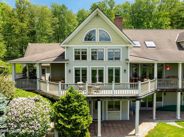 rear view of property featuring a patio and a deck