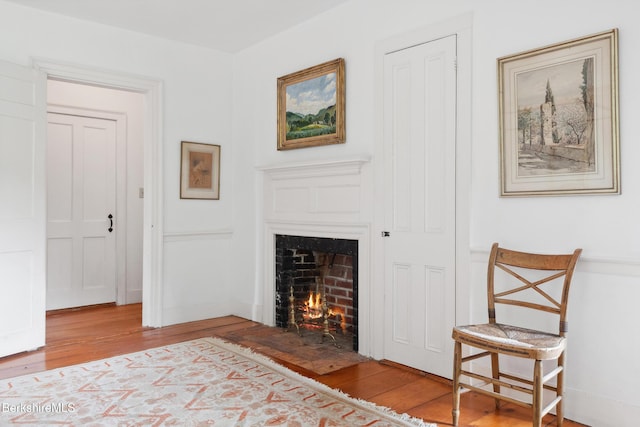 28 Main Rd, Tyringham, MA 01264 - bedroom with a warm lit fireplace and wood finished floors