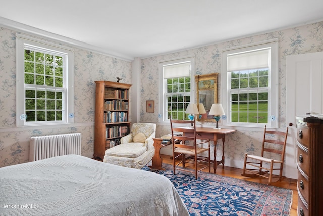 28 Main Rd, Tyringham, MA 01264 - bedroom featuring radiator heating unit, wallpapered walls, multiple windows, and wood finished floors