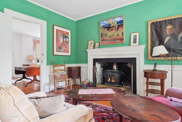 28 Main Rd, Tyringham, MA 01264 - living area with a wood stove, wood finished floors, crown molding, and wainscoting