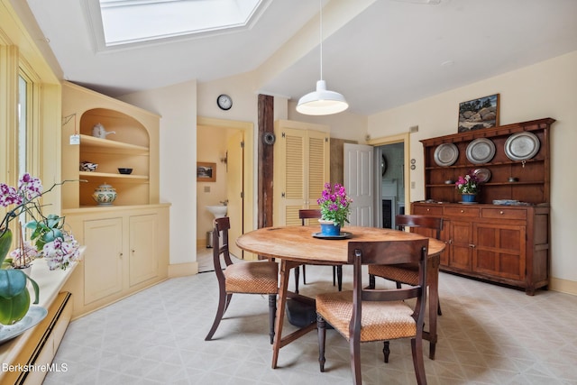 28 Main Rd, Tyringham, MA 01264 - dining room with baseboard heating, light flooring, vaulted ceiling, and a skylight