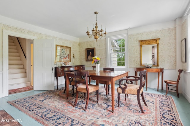 28 Main Rd, Tyringham, MA 01264 - tiled dining space featuring wallpapered walls, stairway, and a chandelier