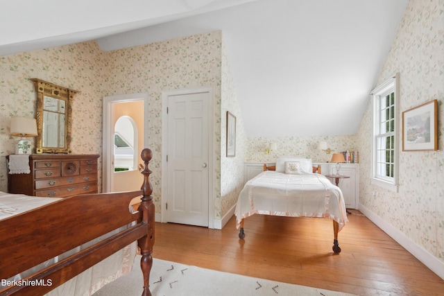 28 Main Rd, Tyringham, MA 01264 - bedroom with wallpapered walls, lofted ceiling, and hardwood / wood-style flooring