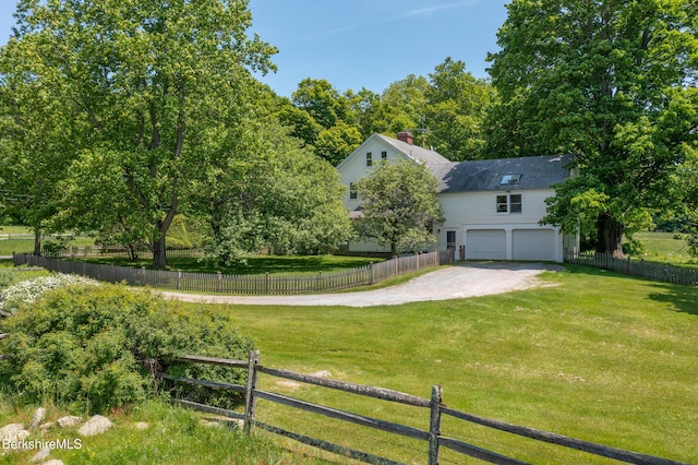 28 Main Rd, Tyringham, MA 01264 - view of yard featuring an attached garage and dirt driveway