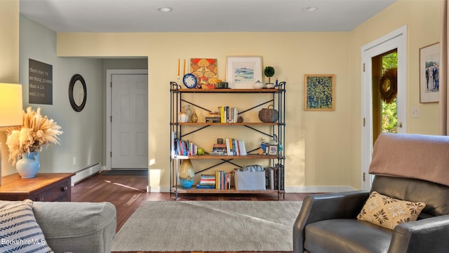 living area with dark hardwood / wood-style floors and a baseboard radiator