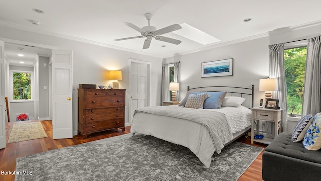 bedroom with dark hardwood / wood-style flooring, ceiling fan, and ornamental molding