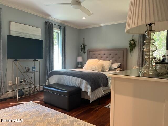 bedroom with dark hardwood / wood-style floors, ceiling fan, and ornamental molding