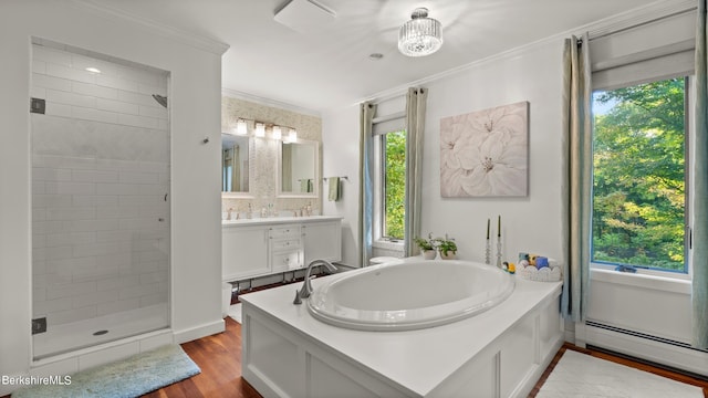 bathroom featuring ornamental molding, vanity, a baseboard heating unit, plus walk in shower, and hardwood / wood-style floors