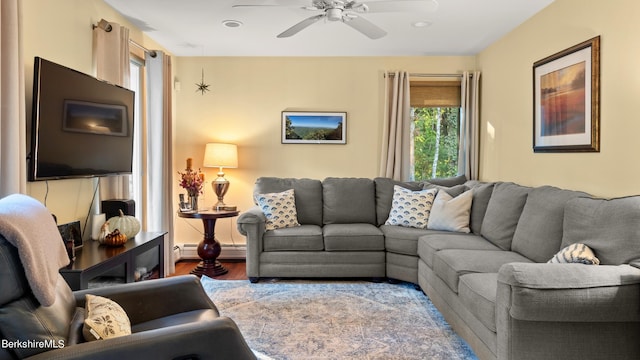 living room featuring hardwood / wood-style floors, ceiling fan, baseboard heating, and a wealth of natural light