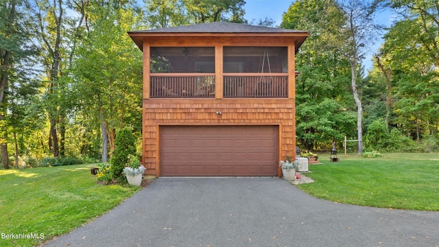 garage featuring a lawn