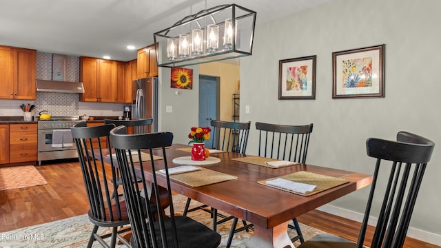 dining room featuring light hardwood / wood-style flooring and a notable chandelier