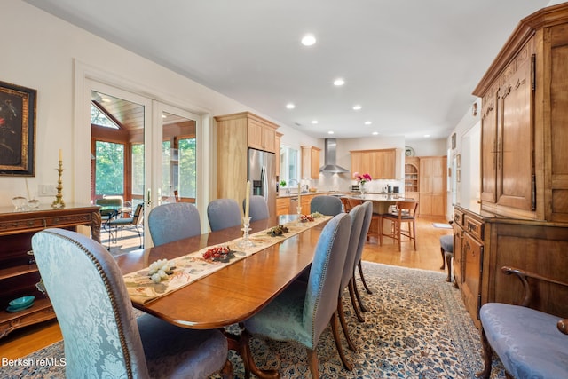 dining room with french doors and light wood-type flooring