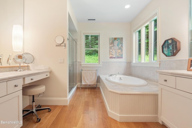 bathroom featuring separate shower and tub, vanity, and wood-type flooring