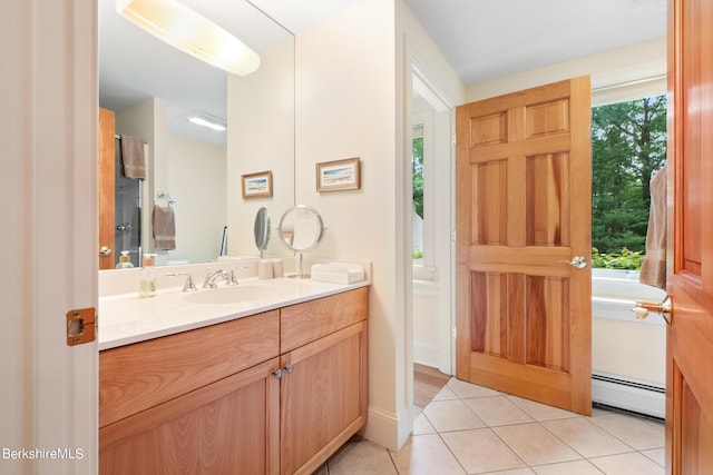 bathroom featuring tile patterned flooring, vanity, and a baseboard heating unit