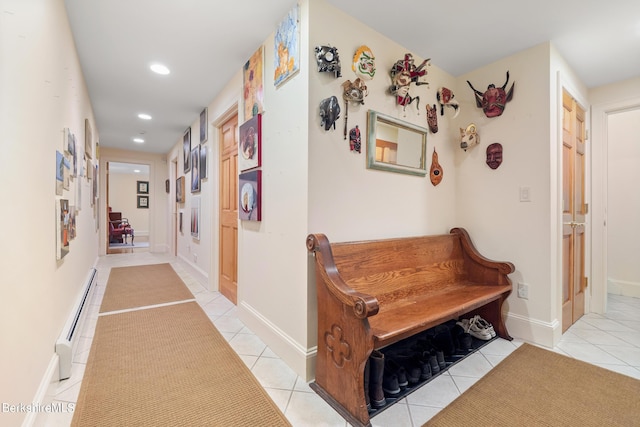 hallway featuring light tile patterned flooring and a baseboard heating unit