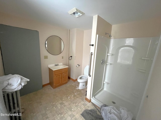 bathroom featuring vanity, toilet, and walk in shower