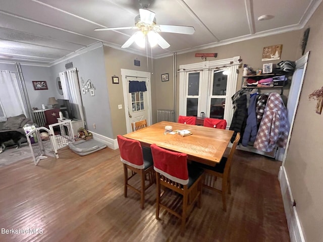 dining room with dark hardwood / wood-style floors, ceiling fan, and ornamental molding