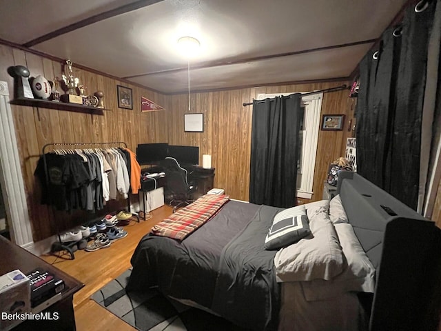 bedroom featuring wooden walls