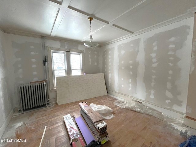 spare room with radiator and coffered ceiling