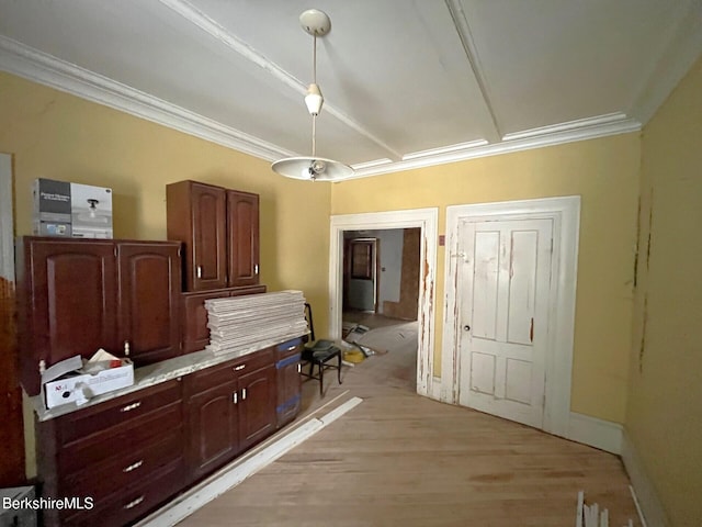 kitchen featuring crown molding and light hardwood / wood-style floors