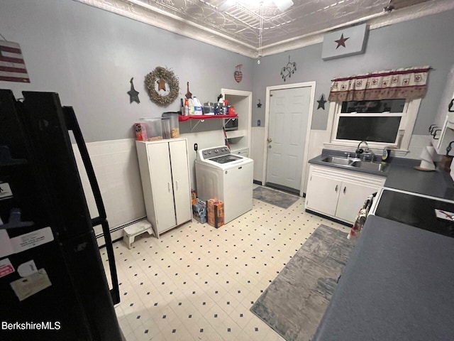 laundry area with cabinets, washer / dryer, and sink