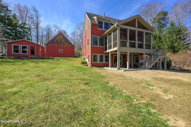 back of property featuring a sunroom, a yard, and a patio