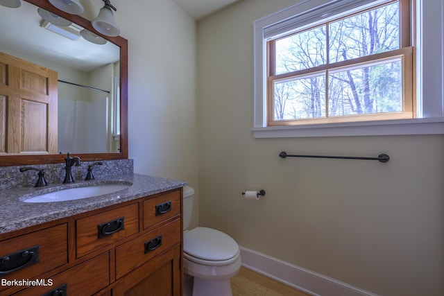 bathroom featuring baseboards, vanity, toilet, and a shower with shower curtain