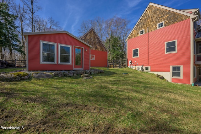 view of property exterior featuring fence and a yard