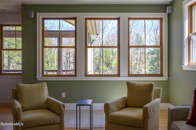 sitting room featuring baseboards and wood finished floors