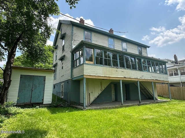 27-29 Daniels Ave, Pittsfield, MA 01201 - back of property featuring a sunroom, a storage shed, a chimney, and a patio