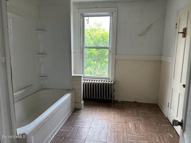 27-29 Daniels Ave, Pittsfield, MA 01201 - bathroom with radiator, tile walls, and shower / bathtub combination