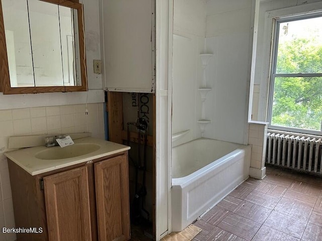 27-29 Daniels Ave, Pittsfield, MA 01201 - full bathroom featuring radiator heating unit, vanity, tile walls, and shower / bathtub combination