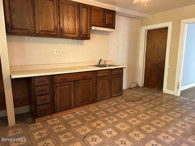 27-29 Daniels Ave, Pittsfield, MA 01201 - kitchen featuring light countertops and dark brown cabinets