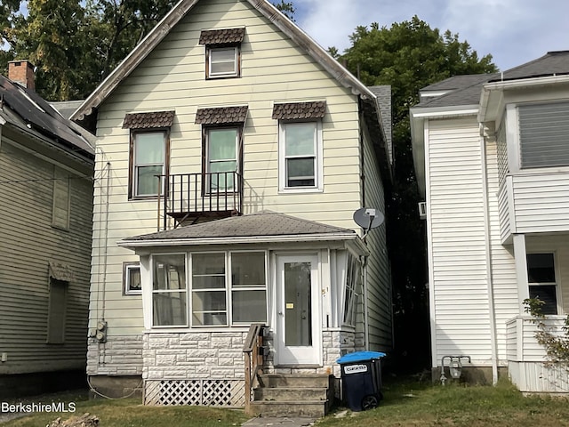 view of front of home featuring a sunroom