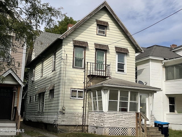 rear view of property with a sunroom