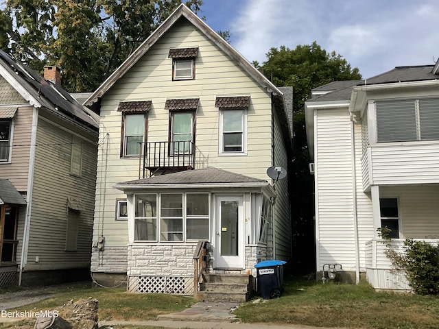 view of front of property with a sunroom