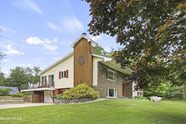 4 Birch Hill Rd, Peru, MA 01235 - view of side of home featuring a chimney, stone siding, a garage, driveway, and a lawn