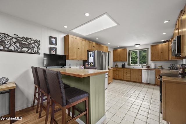 4 Birch Hill Rd, Peru, MA 01235 - kitchen featuring appliances with stainless steel finishes, a peninsula, a kitchen bar, and recessed lighting