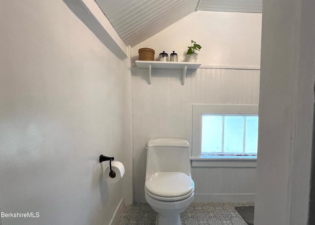 132 Sandisfield Rd, Sandisfield, MA 01255 - bathroom featuring lofted ceiling, toilet, baseboards, and a wainscoted wall