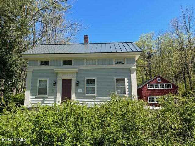 132 Sandisfield Rd, Sandisfield, MA 01255 - view of front of home with a chimney, a standing seam roof, and metal roof