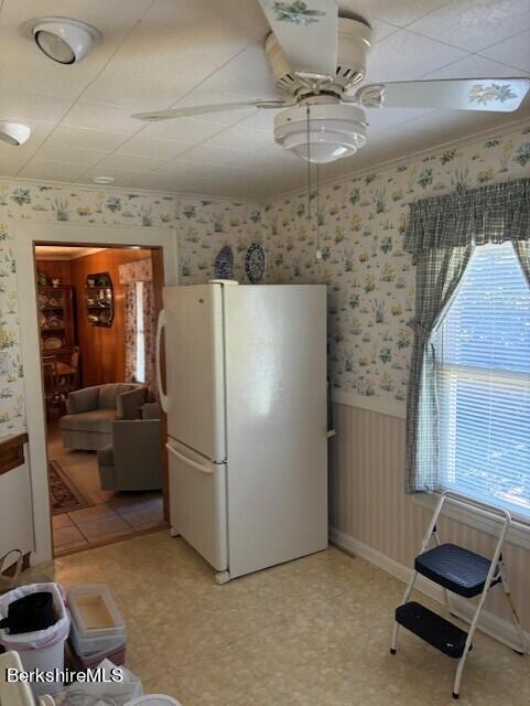 kitchen with ceiling fan, white refrigerator, plenty of natural light, and ornamental molding